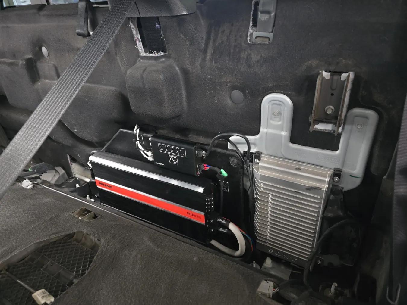 Amplifier and audio electronics installed behind interior trim